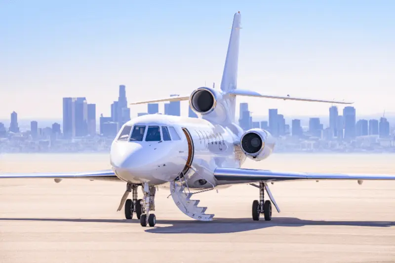 A private jet taking off against the backdrop of a city skyline.