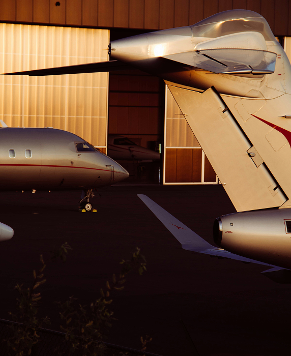 close up of private jet aircrafts outside of hangar