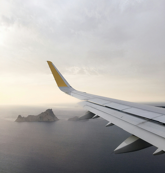 view of private jet wing flying over water