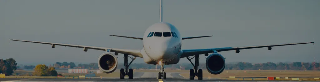 Front view of a private jet on a runway during daylight, representing aviation insights and the latest travel news